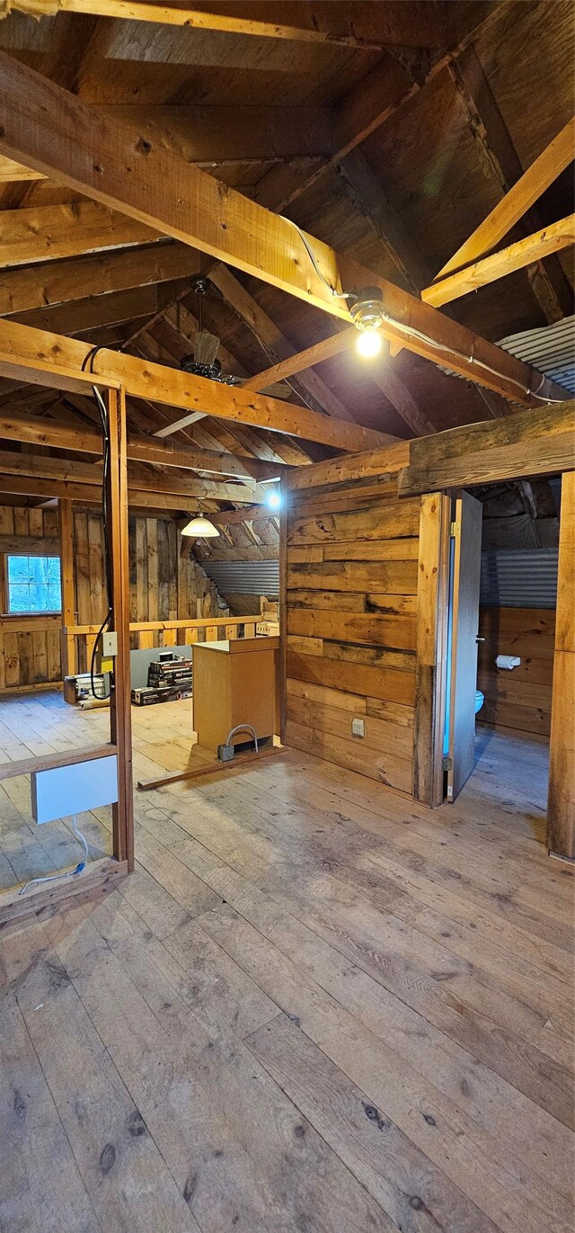 basement featuring wood walls and wood finished floors