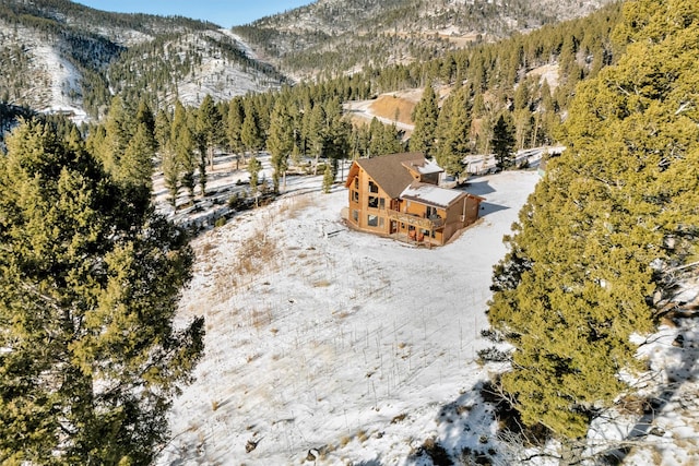 drone / aerial view with a mountain view and a forest view