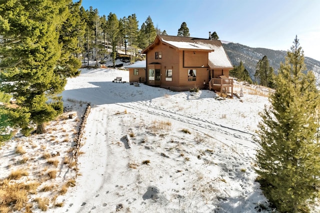 view of snow covered exterior featuring a mountain view