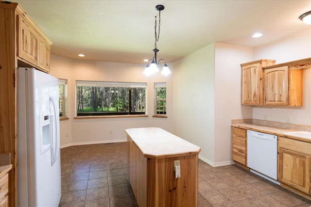 kitchen featuring white appliances, an inviting chandelier, hanging light fixtures, light brown cabinetry, and a kitchen island