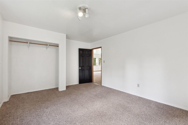 unfurnished bedroom with carpet and a closet