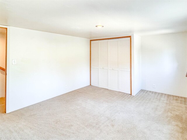 unfurnished bedroom with a closet and carpet floors