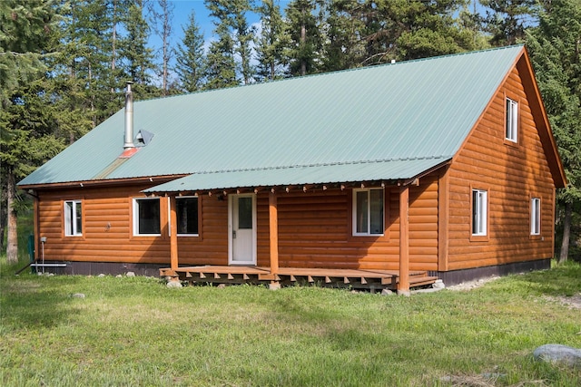 8100 US Highway 2 W, Marion, MT 59925 - view of front of home featuring a front lawn, faux log siding, and a metal roof
