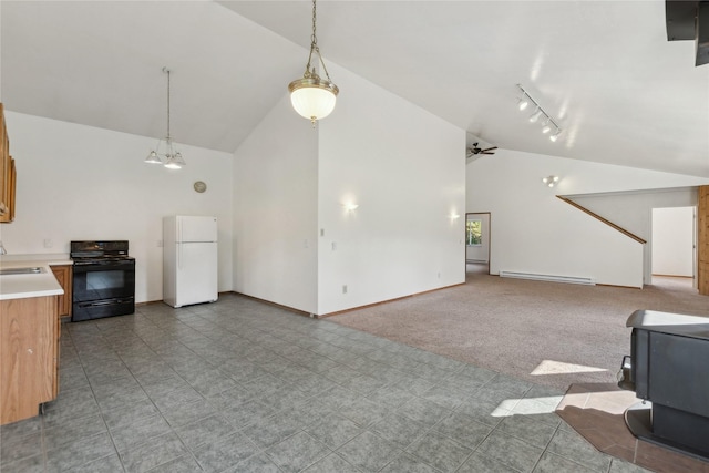 8100 US Highway 2 W, Marion, MT 59925 - unfurnished living room with a baseboard radiator, a wood stove, rail lighting, high vaulted ceiling, and a ceiling fan