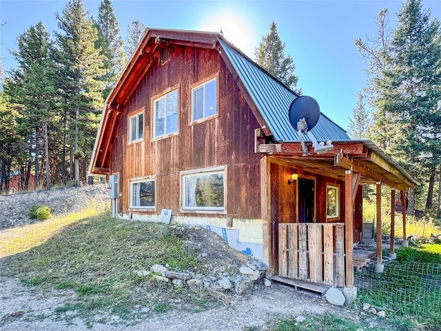 8100 US Highway 2 W, Marion, MT 59925 - view of side of property featuring a metal roof, a standing seam roof, and a gambrel roof