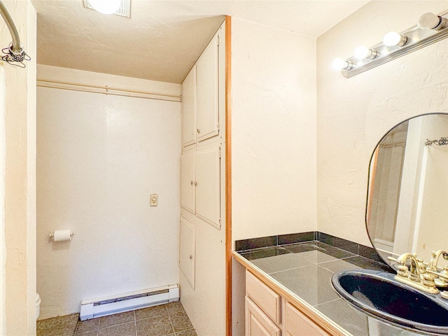 8100 US Highway 2 W, Marion, MT 59925 - bathroom with baseboard heating, vanity, and tile patterned flooring