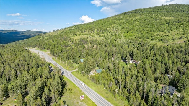 8100 US Highway 2 W, Marion, MT 59925 - drone / aerial view of a heavily wooded area and a mountain backdrop