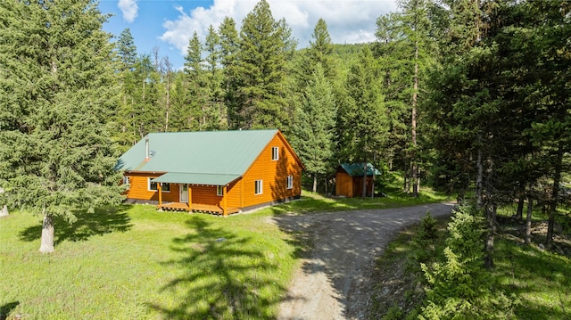 8100 US Highway 2 W, Marion, MT 59925 - view of side of home with a shed, a forest view, a yard, and a metal roof