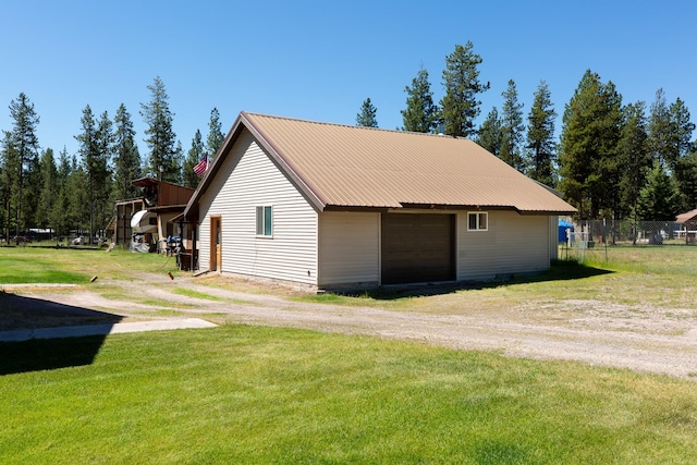 view of side of property with an outbuilding, a yard, and a garage