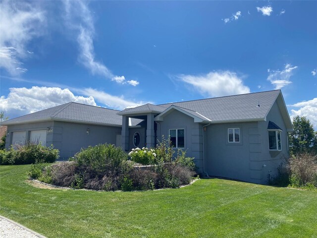 view of home's exterior featuring a garage and a lawn