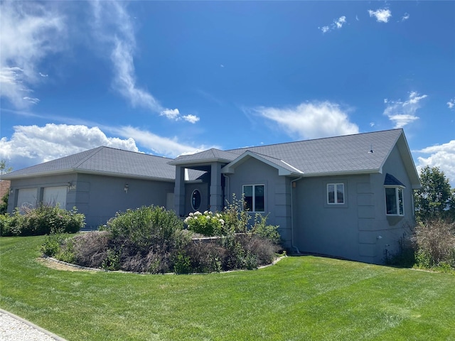 view of front of home with a garage and a front yard