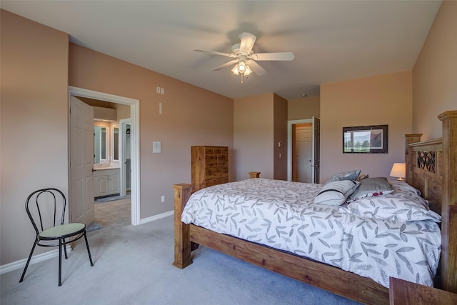 carpeted bedroom with connected bathroom and ceiling fan