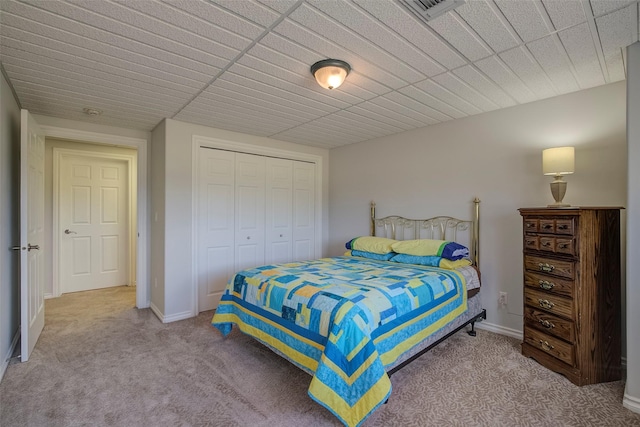 carpeted bedroom featuring a closet