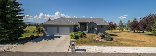 view of front of property with a garage and a front lawn