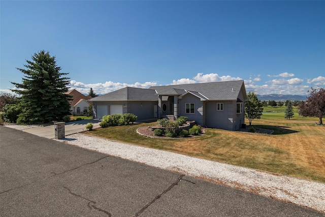 view of front of property featuring a garage and a front yard