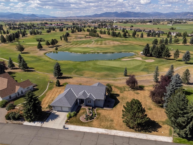 birds eye view of property with a water and mountain view