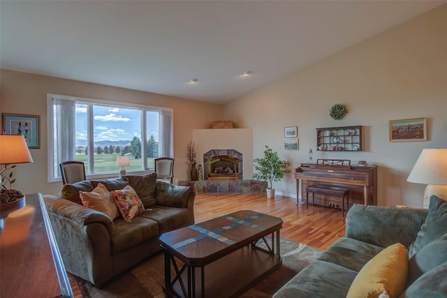 living room with lofted ceiling and hardwood / wood-style flooring