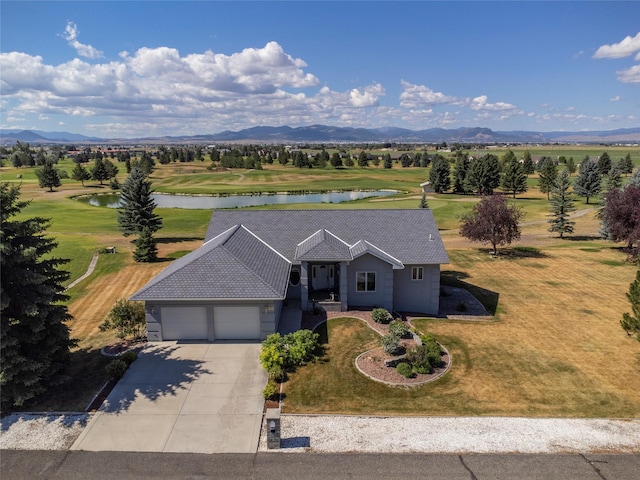 single story home featuring a garage, a water and mountain view, and a front yard