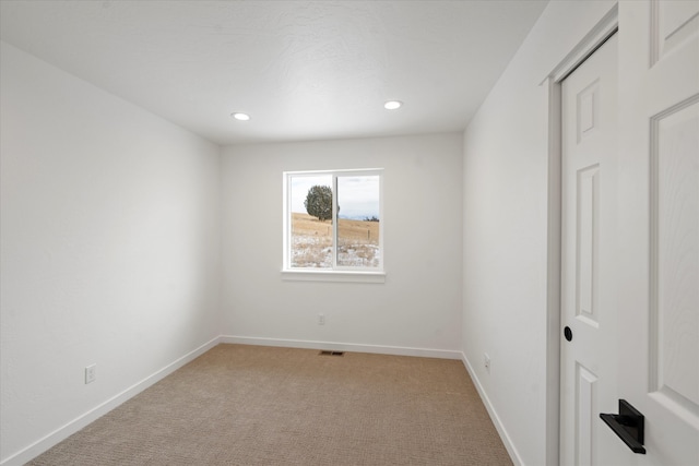 spare room with light carpet