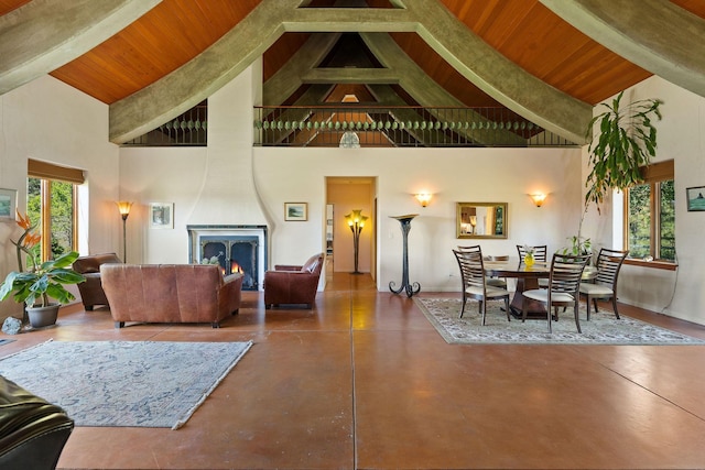 living room featuring high vaulted ceiling, a large fireplace, concrete floors, and wood ceiling