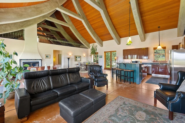 living room featuring wooden ceiling, beamed ceiling, concrete flooring, and high vaulted ceiling