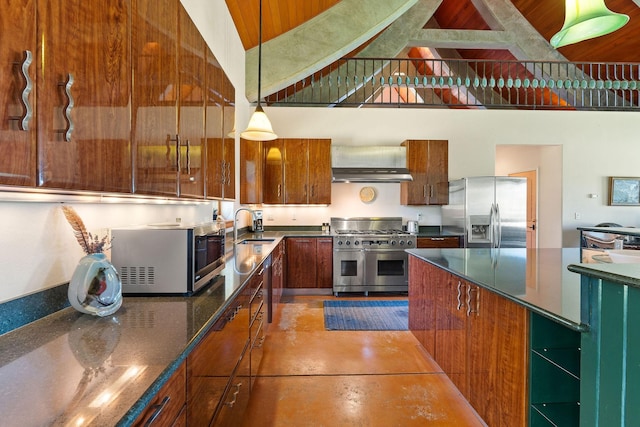 kitchen with a towering ceiling, tile patterned floors, stainless steel appliances, sink, and hanging light fixtures