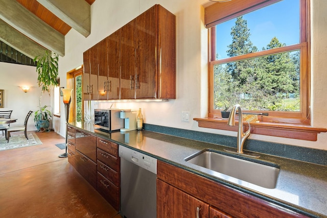233 Coverdell Rd, Bigfork, MT 59911 - kitchen with stainless steel appliances, dark countertops, finished concrete floors, and brown cabinets
