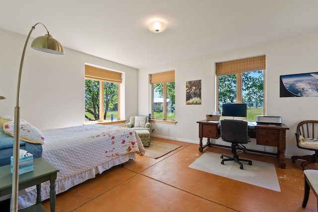 bedroom featuring concrete flooring