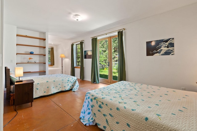 bedroom featuring concrete flooring and access to outside