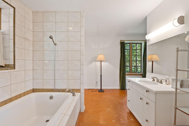 bathroom featuring tiled bath, vanity, and tile patterned flooring