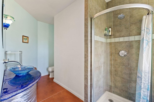 bathroom featuring toilet, tile patterned floors, and curtained shower