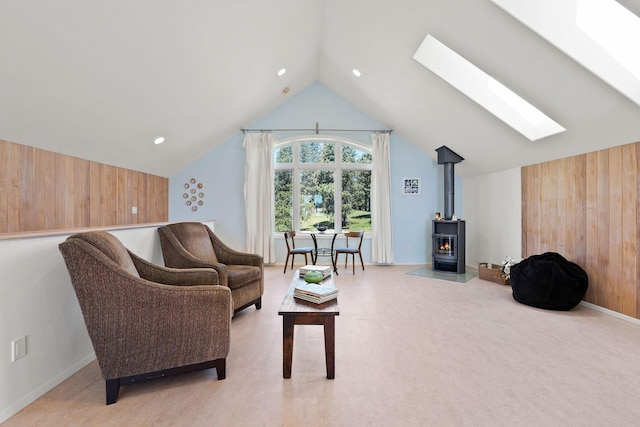 233 Coverdell Rd, Bigfork, MT 59911 - living area with a skylight, lofted ceiling, a wood stove, and wooden walls