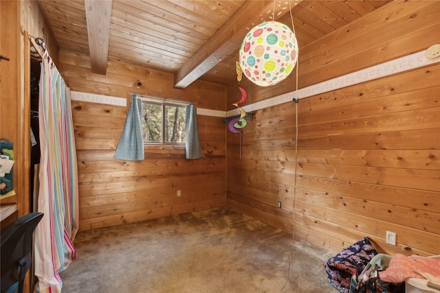 interior space with wood ceiling, beam ceiling, and wooden walls