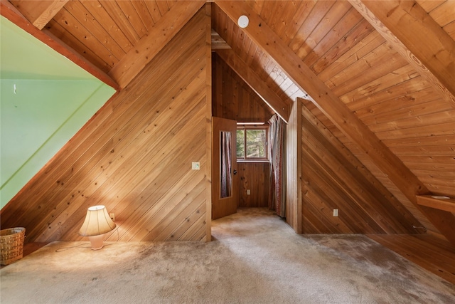 additional living space with carpet floors, vaulted ceiling with beams, wood ceiling, and wooden walls