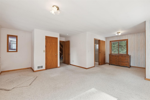 empty room with light carpet, baseboards, and visible vents