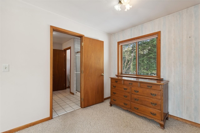 bedroom with light carpet and baseboards