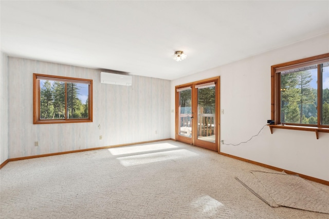 spare room with carpet, a wall mounted air conditioner, and baseboards