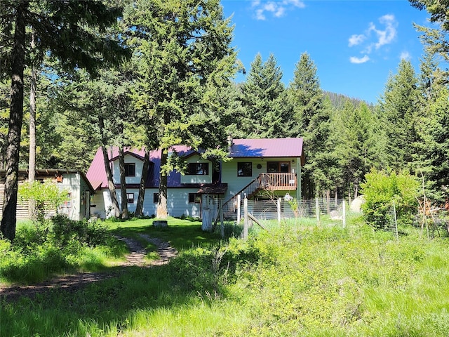 view of front facade with metal roof and a wooden deck