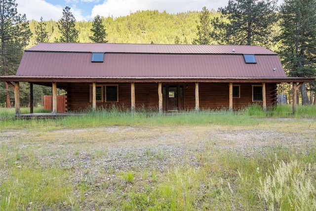 view of stable featuring a forest view