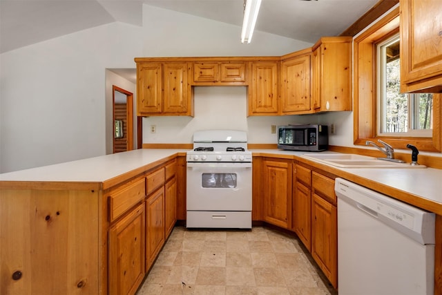 kitchen featuring a sink, light countertops, white appliances, vaulted ceiling, and a peninsula