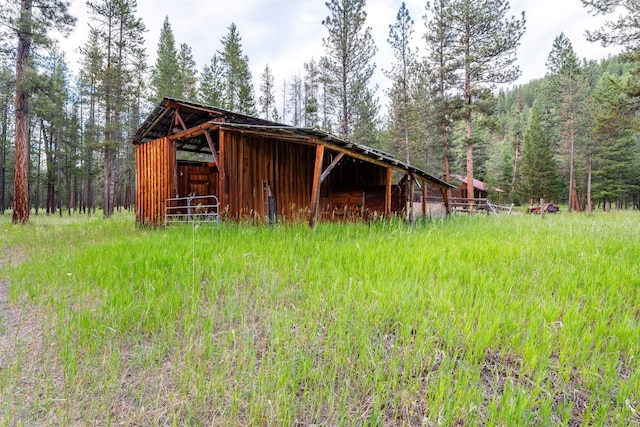 view of outbuilding with a view of trees and an outdoor structure