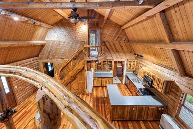 interior space featuring a baseboard heating unit, light wood finished floors, wooden ceiling, track lighting, and beamed ceiling