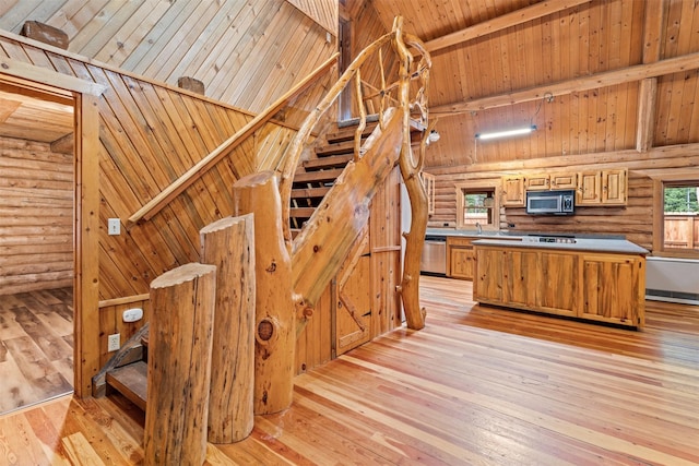 kitchen with appliances with stainless steel finishes, high vaulted ceiling, wooden ceiling, light wood-type flooring, and beamed ceiling