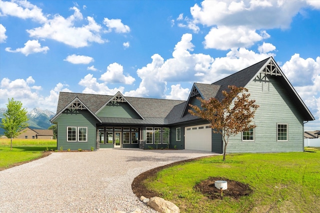 craftsman house with a front yard and a garage