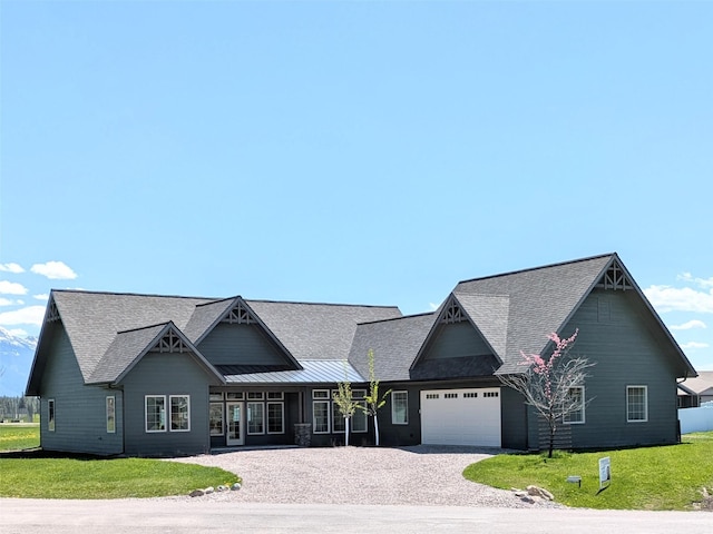585 Dayton St SE, Ronan, MT 59864 - view of front of property with an attached garage, roof with shingles, driveway, and a front lawn