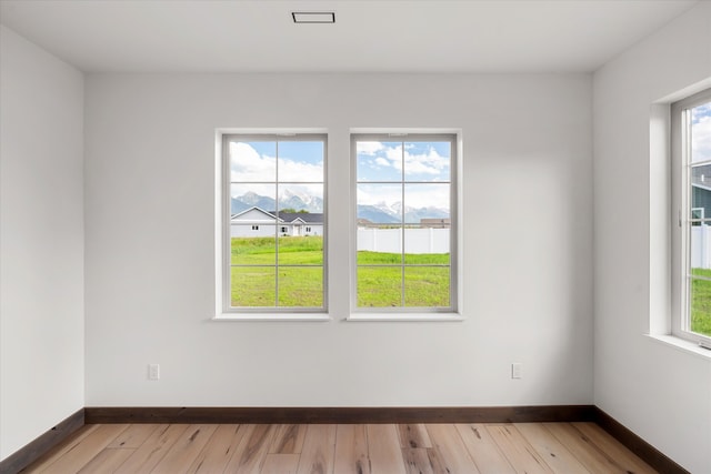 spare room with hardwood / wood-style floors