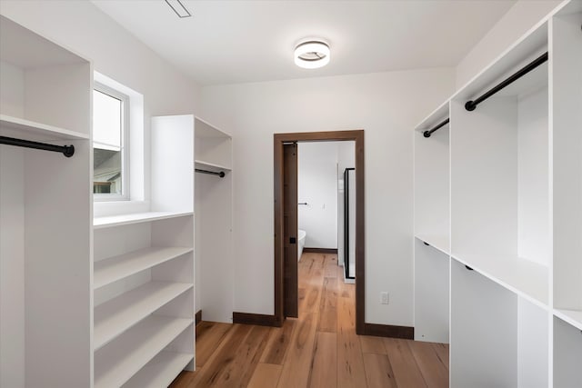 spacious closet featuring light hardwood / wood-style floors