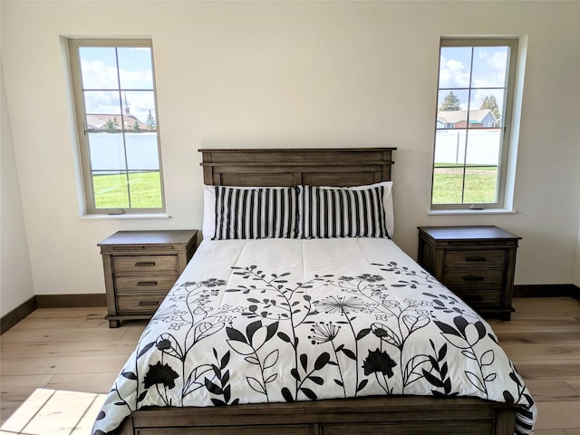 585 Dayton St SE, Ronan, MT 59864 - bedroom with light wood-style floors and multiple windows
