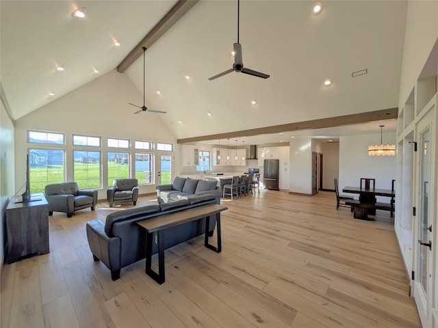 585 Dayton St SE, Ronan, MT 59864 - living area with high vaulted ceiling, beam ceiling, a ceiling fan, a chandelier, and light wood-style flooring
