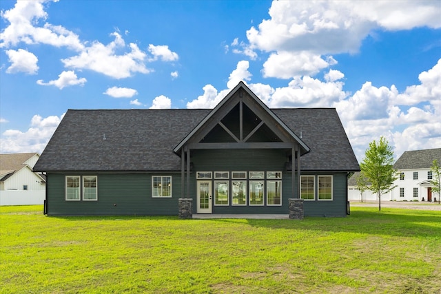 rear view of property featuring a yard